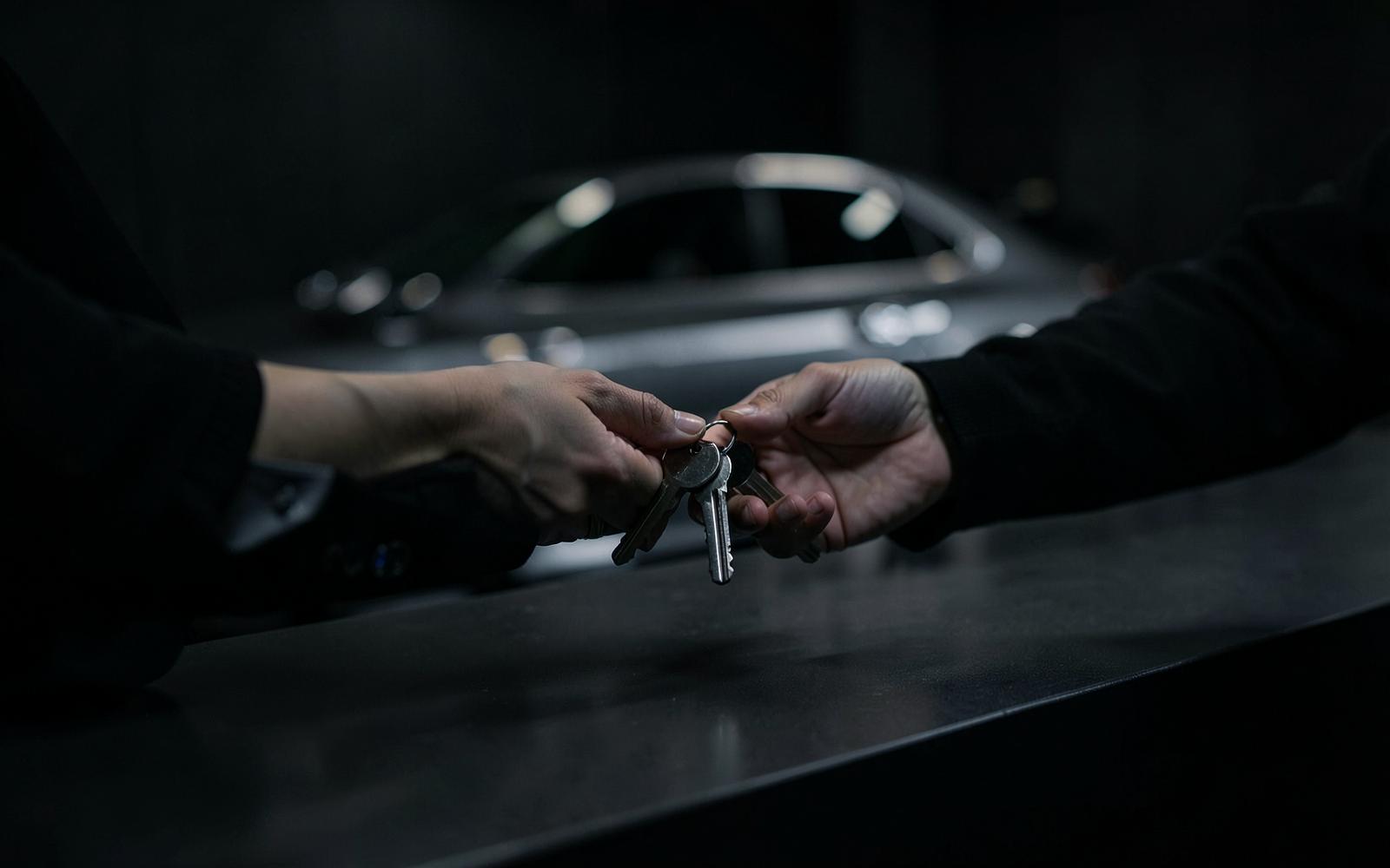 Car keys handed over at a rental desk